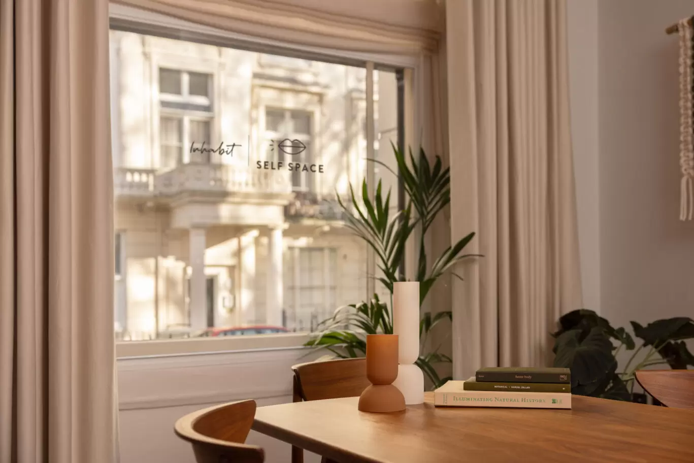 inhabit x self space area with table and plants