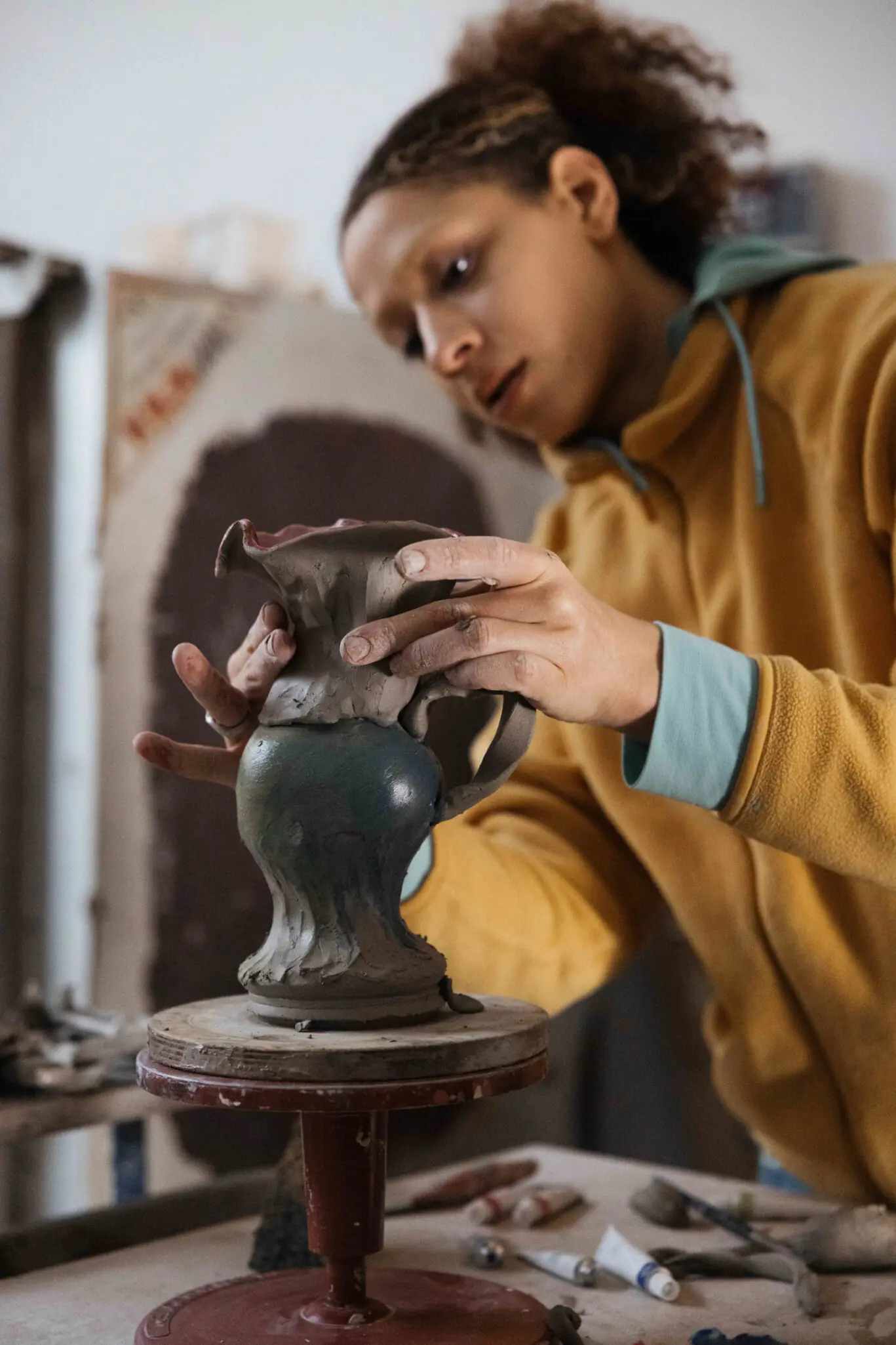 lady painting pottery in studio